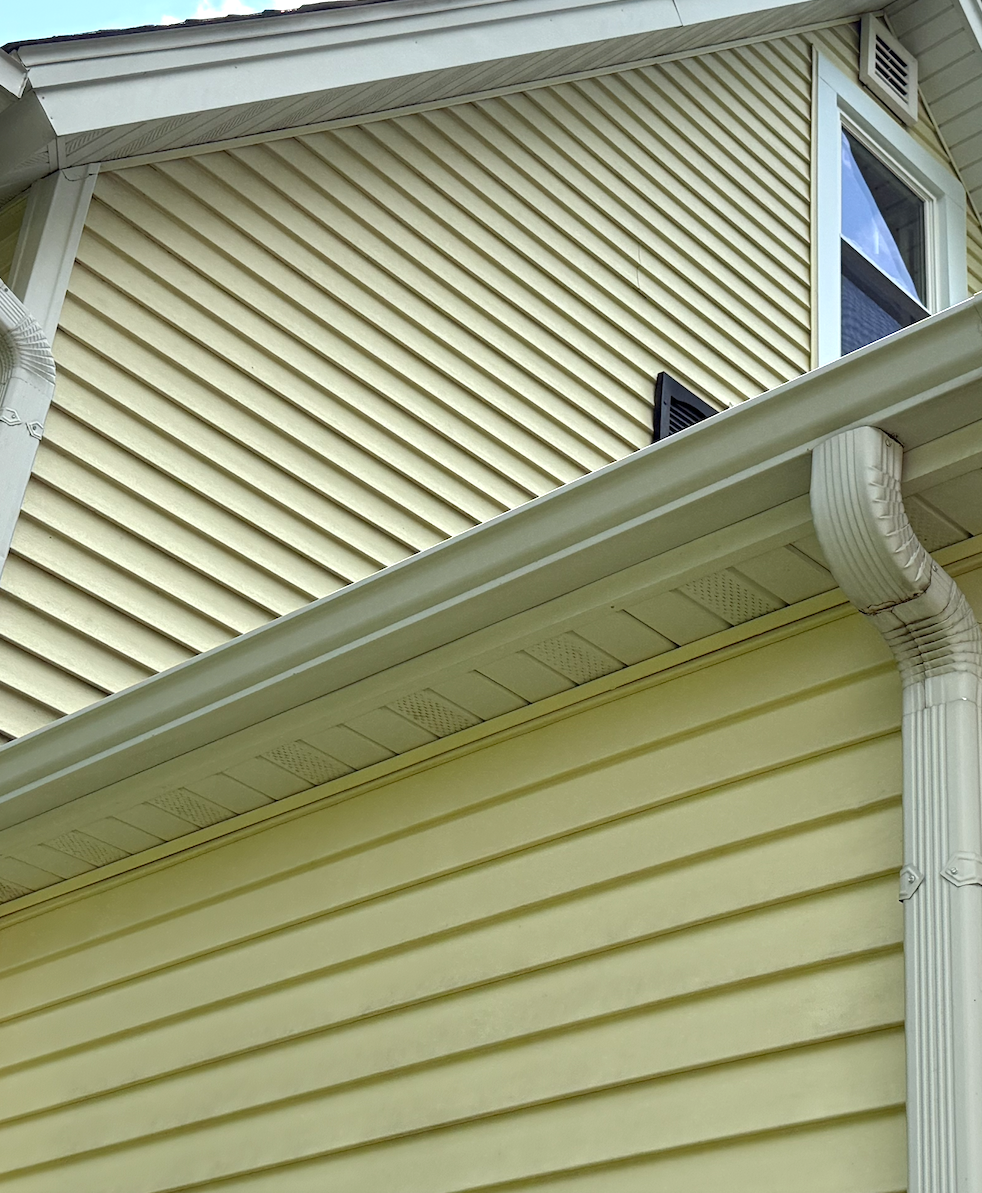 Restored bright white gutter and downspout after Bin Bros gutter restoration in Elmhurst, IL