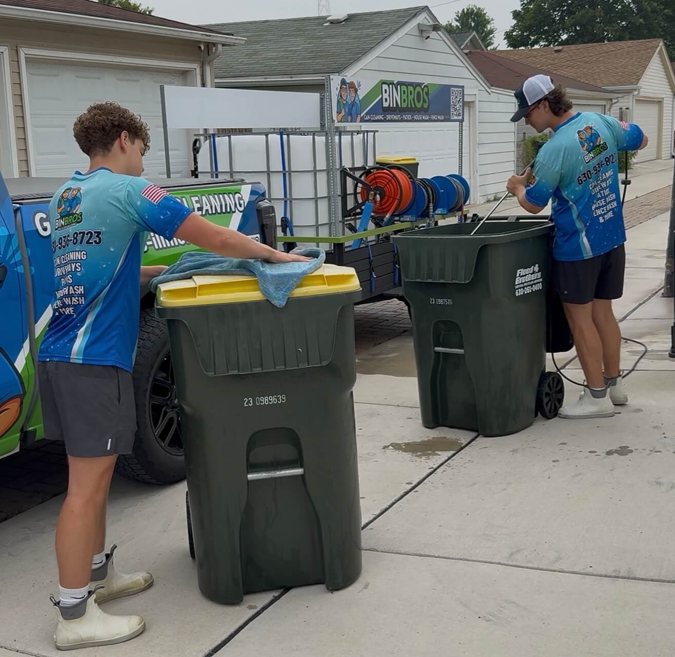 Bin Bros team cleaning and sanitizing garbage cans on a driveway in Elmhurst, IL