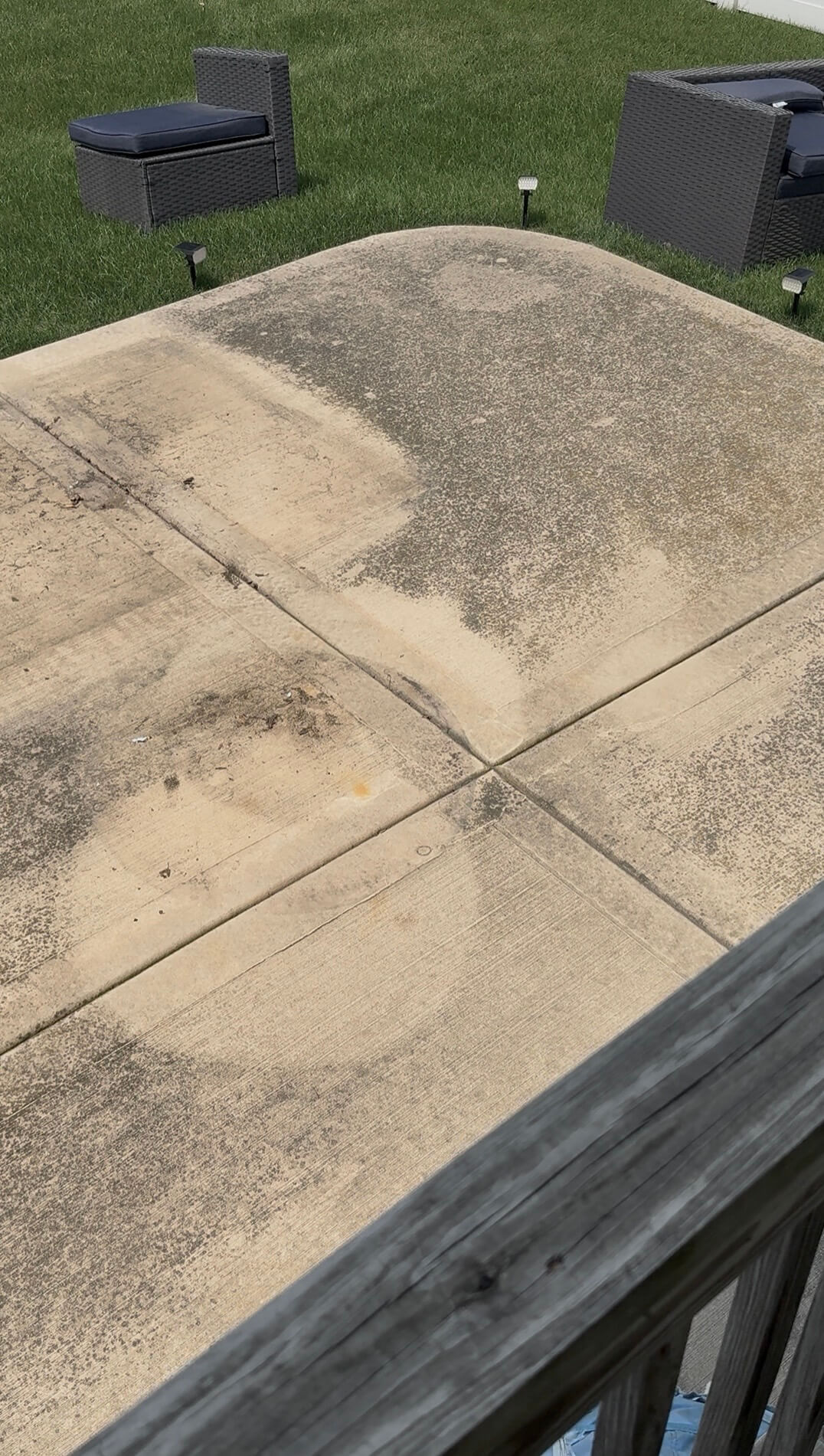 Dirty stained concrete patio with mildew and dirt before pressure washing in Elmhurst, IL